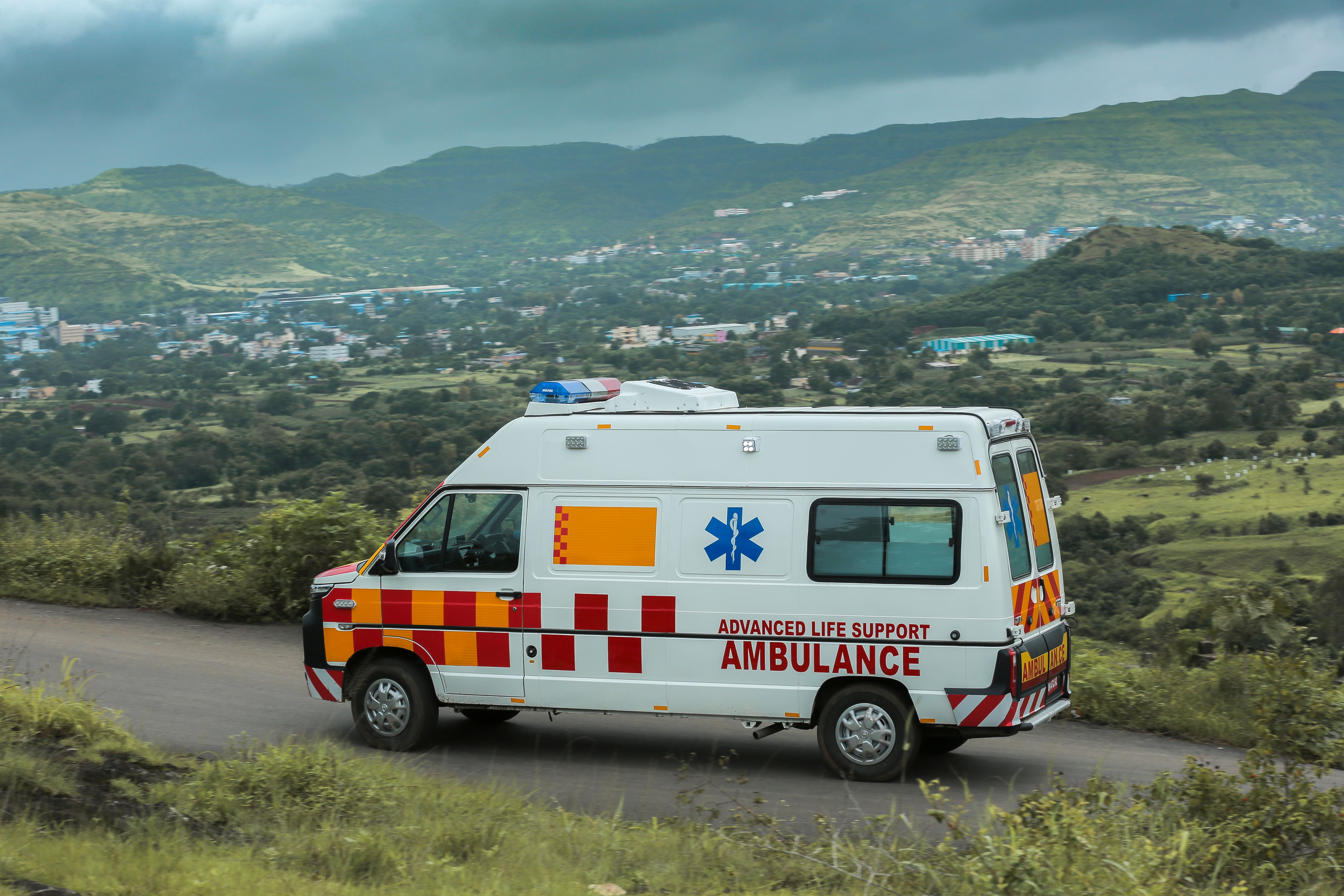 Indian advanced life support ambulance on road — Meghana Ambulance Service Bangalore